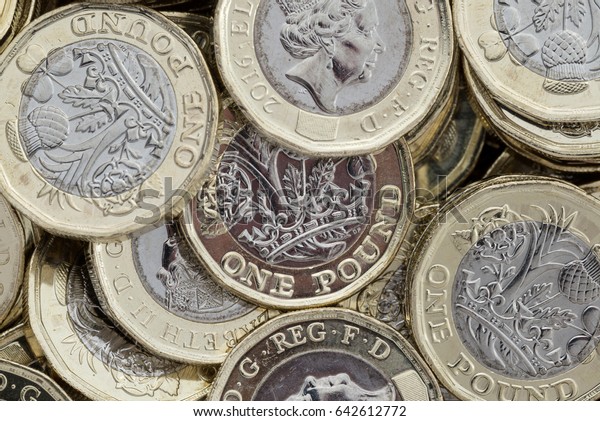 Close up of new British pound coins.
Untidy pile of the new coins introduced in March 2017 that have
several new security features to help prevent
fraud.