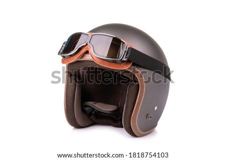Close up new grey vintage helmet and wind goggle. Studio shot isolated on white background