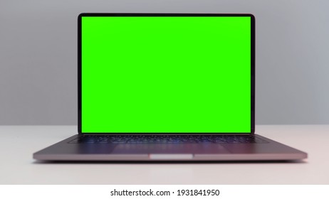 Close up of a new laptop computer with chroma key monitor. Action. Opened laptop with green screen isolated on white wall background. - Powered by Shutterstock