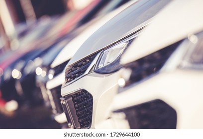 Close Up Of New Luxury Car Dealership Inventory With Passeger Vehicles Parked In Garage. 