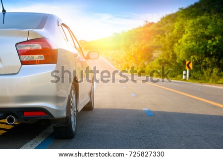 Close up of new silver hatchback car parking on local road