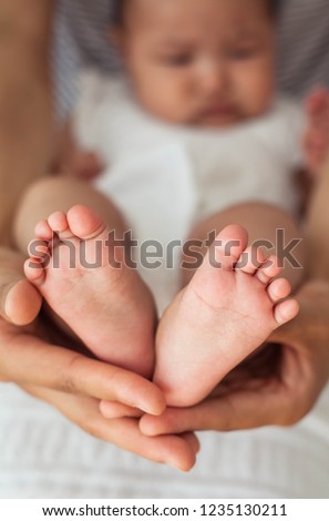 Close up of newborn baby feet. Baby's feet in the mother hands. Baby. Cozy. Family.