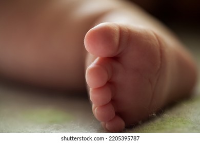 Close Up Of Newborn Baby Leg. Beautiful Newborn Baby Legs On A Soft Blanket