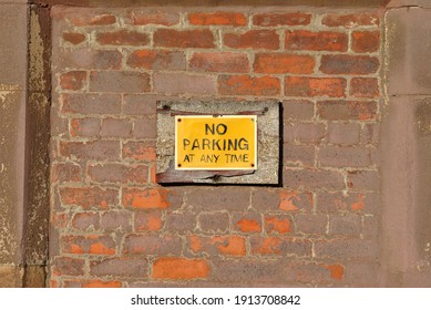 Close Up of 'No Parking' Sign on Old Brick Wall  - Shutterstock ID 1913708842