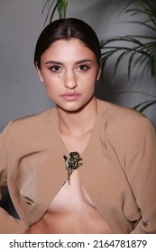 Close Up Non Retouched Image Of Brunette Model With A Big Mole On Her Face, Professional Make Up And Up-do Hairstyle. Unconventional Beauty Body Positivism. Brown Blazer Decorated With Pin Brooch