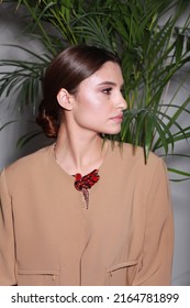 Close Up Non Retouched Image Of Brunette Model With A Big Mole On Her Face, Professional Make Up And Up-do Hairstyle. Unconventional Beauty Body Positivism. Brown Blazer Decorated With Pin Brooch