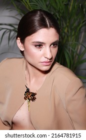 Close Up Non Retouched Image Of Brunette Model With A Big Mole On Her Face, Professional Make Up And Up-do Hairstyle. Unconventional Beauty Body Positivism. Brown Blazer Decorated With Pin Brooch