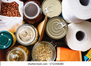 Close up of non-perishable food, canned goods and toilet paper. Overhead view. - Shutterstock ID 1712358280