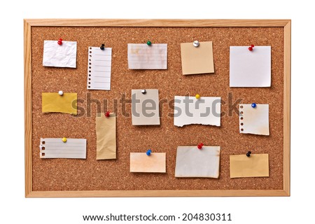 close up of note papers on a cork board