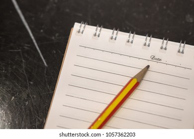 Close up of notebook with pencil.