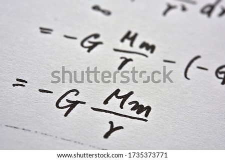 Close up of the notes with the formula for the law of universal gravitation.