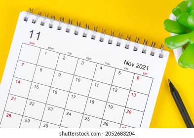 Close up November 2021 desk calendar on yellow background.