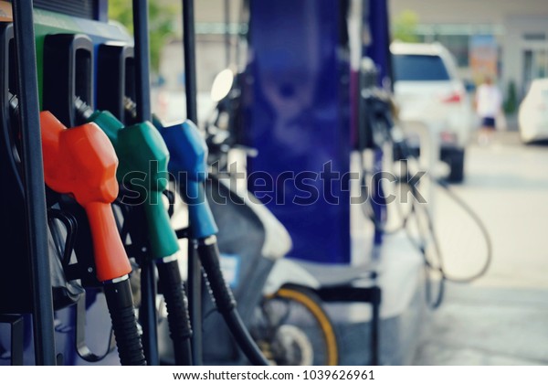 close\
up of nozzle fuel for fill oil into car tank at pump gas station,\
saving money and energy for transport, transportation technology,\
manage for success business concept, vintage\
tone
