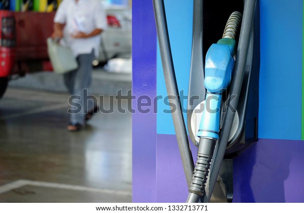 close up nozzle fuel for fill oil into car or\
motorcycle tank at pump gas station, transport energy,\
transportation power business technology\
concept