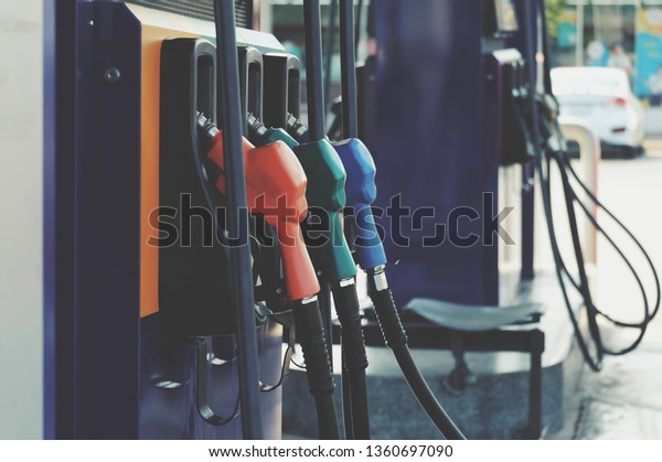 close up nozzle fuel for fill oil
into car or motorcycle tank at pump gas station, transport energy,
transportation power business technology concept, vintage
tone