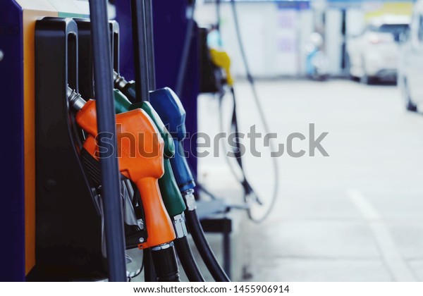 close up nozzle fuel for fill oil into car tank\
at pump gas station, transport energy, transportation power\
business technology\
concept