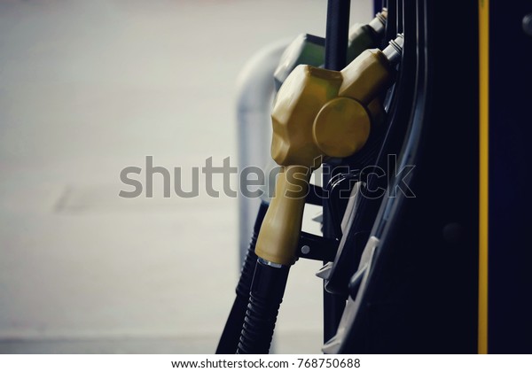 close up nozzle fuel in gas station\
with copy space background, saving energy and money for transport,\
manage for success business concept, vintage\
tone