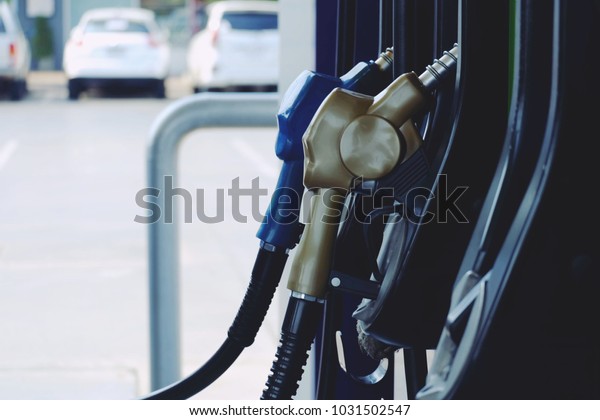close up\
nozzle fuel in pump gas station, saving money and energy for\
transport, transporation technology\
concept