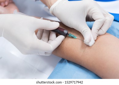 Close up nurse hand collecting blood sample for diagnosis and treatment patient in the hospital.Laboratory technician taking blood for blood chemistry diagnosis by automatic machine.
