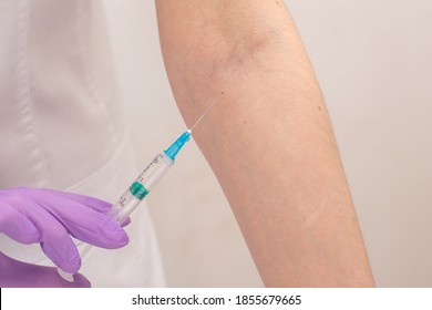 Close Up Nurse Hands On Gloves Makes An Injection To Hand Patient.