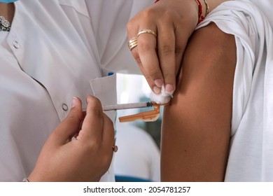 Close up of nurse injecting vaccine to an unrecognizable person. Concept of vaccination. - Shutterstock ID 2054781257