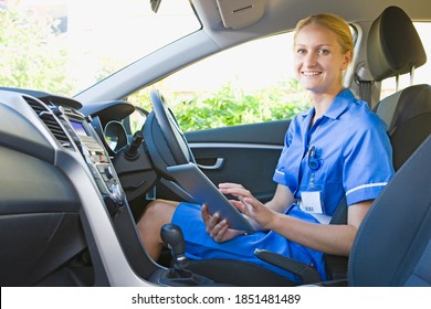 Close up of a nurse sitting in the car and using a digital tablet