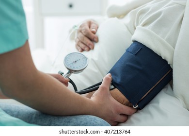 Close Up Of Nurse Taking Blood Pressure