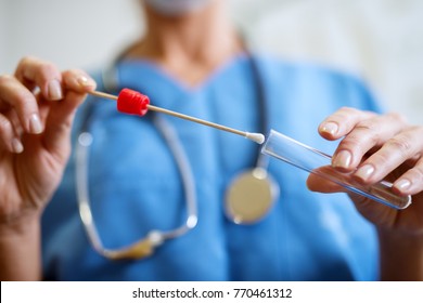 Close up of nurses hands holding buccal cotton swab and test tube ready to collect DNA from the cells. - Shutterstock ID 770461312
