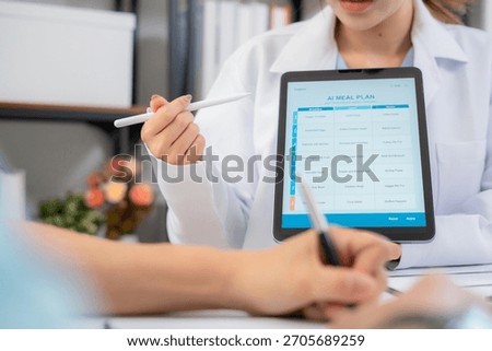 Close up nutritionist using tablet to explaining personalized meal plan with AI to patient during healthcare consultation, healthy lifestyle, woman dietitian showing nutrition plan with AI on tablet.