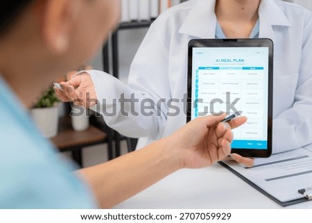 Close up nutritionist using tablet to explaining personalized meal plan with AI to patient during healthcare consultation, healthy lifestyle, woman dietitian showing nutrition plan with AI on tablet.