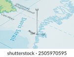 Close up to a Nuuk city with a white pin needle into Greenland country political map 