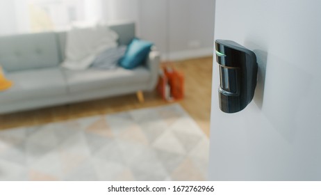 Close Up Object Shot of a Modern Movement Detector Unit on a White Wall in a Cozy Apartment in the Background. - Shutterstock ID 1672762966