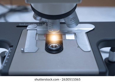 Close up objective lens microscope in laboratory. Examining histological sample, a biopsy in the laboratory of cancer research. Modern technology using a microscope