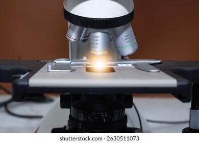 Close up objective lens microscope in laboratory. Examining histological sample, a biopsy in the laboratory of cancer research. Modern technology using a microscope