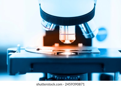 Close up objective lens microscope in laboratory.Examining histological sample, a biopsy in the laboratory of cancer research.Medical patholology and cytology laboratory concept.