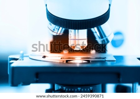 Close up objective lens microscope in laboratory.Examining histological sample, a biopsy in the laboratory of cancer research.Medical patholology and cytology laboratory concept.
