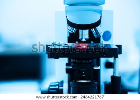Close up objective lens microscope in laboratory.Examining histological sample, a biopsy in the laboratory of cancer research.Medical patholology and cytology laboratory concept.