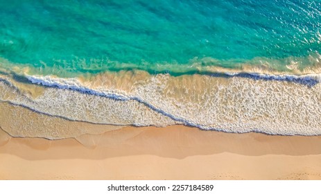 Close up of ocean waves rolling onto a beautiful beach with pink sand at sunrise. Sandy coastline with white turquiose sea waves. Soft wave of the sea on sandy beach with white clean foam - Powered by Shutterstock