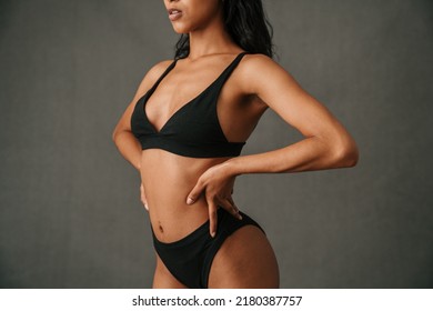  Close up off Multiethnic female standing hands on hips and showing off her toned well body