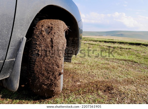 Close up of an\
off-road car\'s tyre covered with mud. Outdoor, adventure and travel\
concept. High quality\
photo
