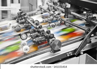 Close up of an offset printing machine during production - Shutterstock ID 141151414