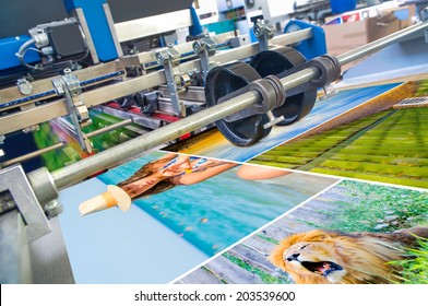 Close up of an offset printing machine during production - Shutterstock ID 203539600