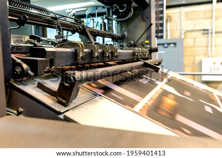 Close up of an offset printing machine during production