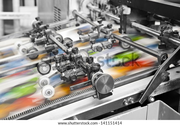 Close\
up of an offset printing machine during\
production