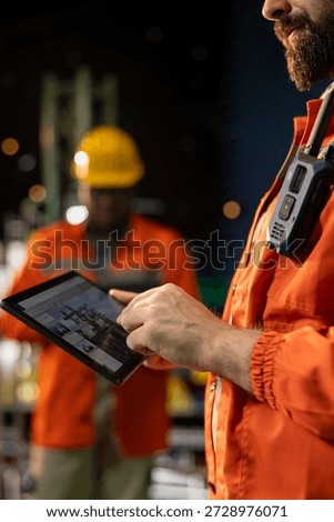 Close up of offshore platform engineer checking equipment status indicators on tablet system dashboard. Worker verifying hydraulic pressure levels on device digital monitoring panel app