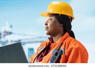 Close up of offshore platform engineer using laptop to coordinate logistics and supply deliveries. Drilling rig worker uses notebook to document safety inspections and hazard reports