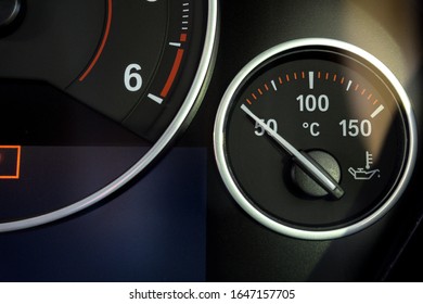 Close up of Oil Temperature Gauges on car dashboard background. 