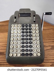 Close Up Of Old Adding Machine On Wooden Desk