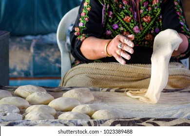 Close up of old Arab woman hands kneading fresh dough for Taboon bread or Lafah is a Middle Eastern  flatbread also called lafa or Iraqi pita.   - Powered by Shutterstock