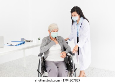 Close Up Old Asian Patient, Female Doctor Diagnosis And Treatment Old Patient, Patient Cough And Feeling Chest Pain, She Sitting On Wheelchair, They Wear Surgical Mask, Respiratory Disease Protection